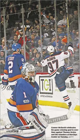  ?? GETTY ?? Connor McDavid celebrates his game-winning goal in overtime against Thomas Greiss and the Islanders at Barclays Center on Tuesday.