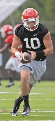  ?? John Roark/Athens Banner-Herald via AP ?? University of Georgia NCAA college football quarterbac­k Jacob Eason (10) receives a snap during the first day of practice, Monday, Aug. 1, 2016, in Athens, Ga.