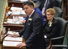  ?? NATHAN DENETTE, THE CANADIAN PRESS ?? Ontario Finance Minister Charles Sousa, left, delivers the 2016 Ontario budget next to Premier Kathleen Wynne, right, in February of last year.