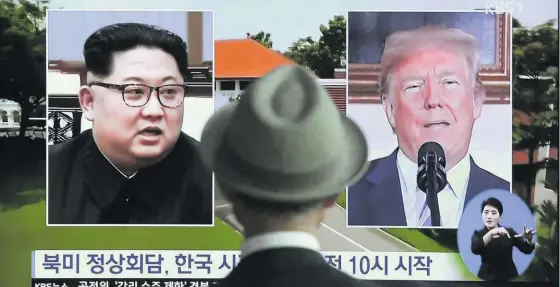  ?? Photo / AP ?? A man at the Seoul Railway Station in South Korea watches file footage of US President Donald Trump and North Korean leader Kim Jong Un.