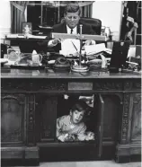  ??  ?? Hide-out: President Kennedy with his son John playing under the desk