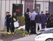  ?? MICHAEL CONROY — THE ASSOCIATED PRESS ?? Authoritie­s confer Friday morning at the FedEx Ground facility in Indianapol­is, where multiple people were shot.