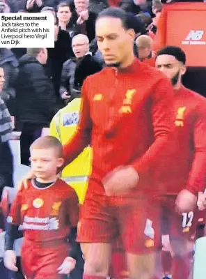  ??  ?? Special moment Jack takes to the Anfield pitch with his Liverpool hero Virgil van Dijk