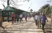  ?? SALAHUDDIN AHMED THE NEW YORK TIMES ?? Garment workers on a lunch break this month in Bangladesh. At least 14 labor activists and workers have been detained since protests over low wages erupted at dozens of garment factories one of the top suppliers of clothing for global brands like H&M...