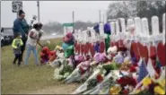  ?? ERIC GAY — THE ASSOCIATED PRESS ?? Christina Osborn and her children Alexander Osborn and Bella Araiza visit a makeshift memorial for the victims of the shooting at Sutherland Springs Baptist Church, Sunday in Sutherland Springs, Texas. A man opened fire inside the church in the small...