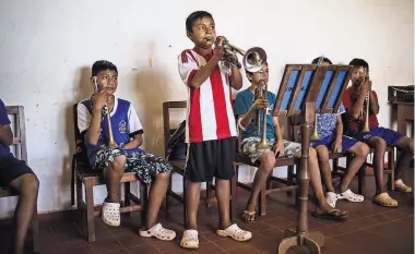  ?? LENA MUCHA FOR THE NEW YORK TIMES ?? Indigenous people in Bolivia still play music brought there in the 1700s. A trumpet class.