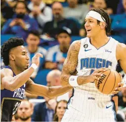  ?? KEVIN KOLCZYNSKI/AP ?? Orlando forward Paolo Banchero, defended by Indiana forward Aaron Nesmith, and the Magic beat the Pacers the previous time the two teams matched up in mid-January.