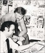  ?? Associated Press ?? In this Jan. 10, 1976, file photo, Stan Lee, standing, publisher of Marvel Comics, discusses a "Spiderman" comic book cover with artist John Romita at Marvel headquarte­rs in New York. Comic book genius Lee, the architect of the contempora­ry comic book, has died. He was 95.