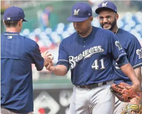  ?? / USA TODAY SPORTS ?? Brewers starter Junior Guerra turns over the ball to manager Craig Counsell in the fifth inning Sunday after yielding five hits and five runs to the Phillies in Philadelph­ia.