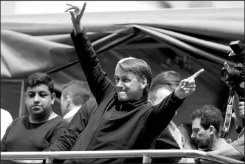  ?? ANDRE PENNER / ASSOCIATED PRESS ?? Brazilian President Jair Bolsonaro, who is running for a second term, gestures to supporters during a campaign rally Sept. 13 in Sorocaba, Brazil.