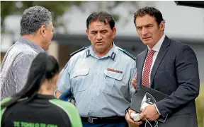  ?? MARK BAKER/AP ?? Paul Quinn, left, chairman of White Island Tours, in discussion­s with Police Minister Stuart Nash, right, and police deputy commission­er Wally Haumaha.