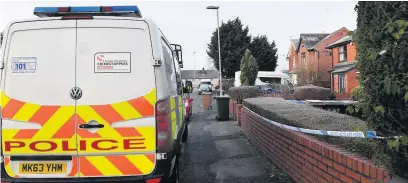  ??  ?? ●●A police vehicle outside the taped off home on Belfield Mill Lane