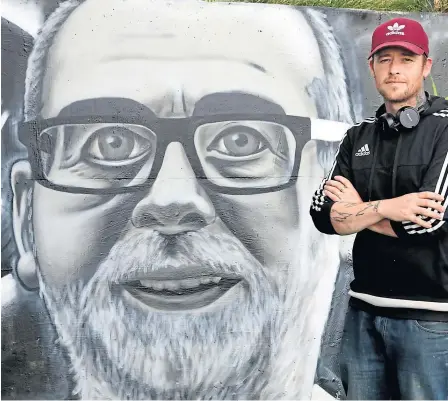  ??  ?? Symon Mathieson beside his mural of Breeks in the Tayview Community Garden.