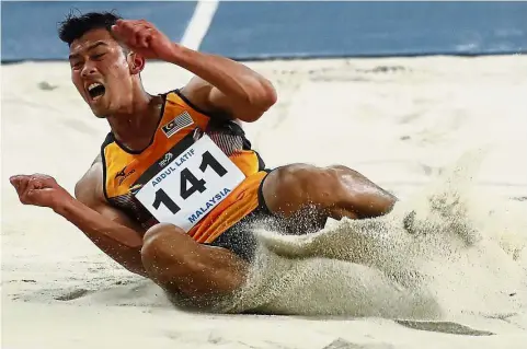  ??  ?? Under theweather: Abdul Latif Romly in action during the long jump at the National Stadium in Bukit Jalil yesterday.