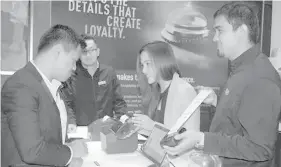  ??  ?? Epson representa­tives explain to booth visitors how their advanced solutions can help businesses innovate and create customer experience­s at the 4th Retail Technology and Innovation Summit Asia held at the City of Dream Manila in Parañaque City.