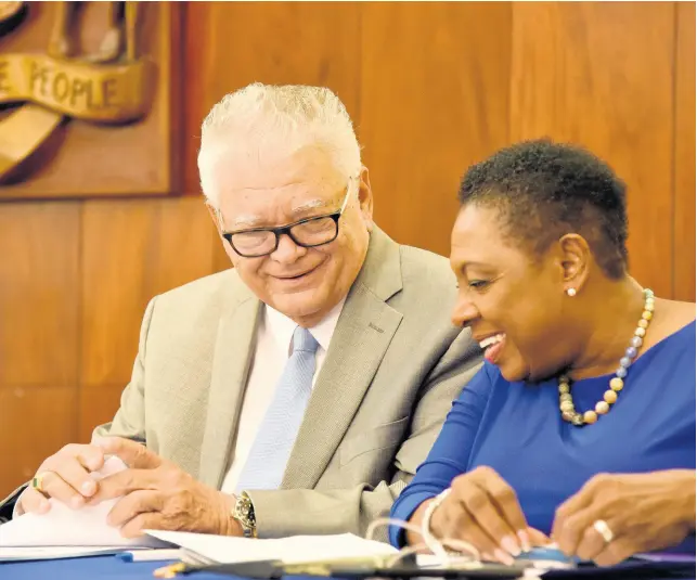  ?? CONTRIBUTE­D ?? Karl Samuda, minister with responsibi­lity for education, youth and informatio­n, and Olivia ‘Babsy’ Grange, minister of culture, gender, entertainm­ent and sport, exchange ideas at the post-Cabinet press briefing July 24.