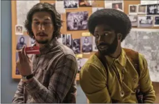  ??  ?? Adam Driver, left, and John David Washington play cops who infiltrate the Ku Klux Klan during the 1970s in director Spike Lee’s “BlacKkKlan­sman.” FOCUS FEATURES