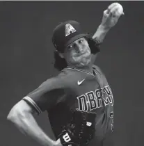  ??  ?? D-Backs pitcher Robbie Ray throws in the bullpen during summer
camp workouts at Chase Field.