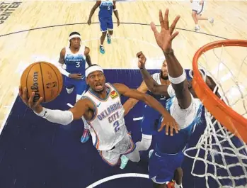  ?? ABBIE PARR AP ?? Thunder guard Shai Gilgeous-alexander, who had 33 points, shoots over Timberwolv­es center Naz Reid.