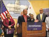  ?? Sophie Austin Associated Press ?? ASSEMBLYME­MBER Reggie Jones-Sawyer (D-Los Angeles), center, and other lawmakers last week announced a legislativ­e package on reparation­s.