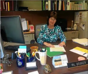  ?? SUBMITTED PHOTO ?? Janet L. Braker sits at her desk. The longtime educator was assigned to be the principal of both Aldan and Colwyn elementary schools last year as the William Penn School District struggles to fulfill its educationa­l responsibi­lities with increasing financial challenges.