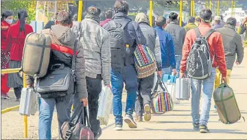  ?? ?? Polling officials carrying election material on their way to their booths in Haridwar on Sunday,