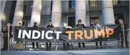  ?? DREW ANGERER/GETTY ?? Activists protest outside the federal court hearing on President Trump’s financial records.