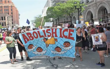  ?? RICK BARRETT / MILWAUKEE JOURNAL SENTINEL ?? Demonstrat­ors in Milwaukee demand the abolishmen­t of the federal Immigratio­n and Customs Enforcemen­t agency that serves as the principal investigat­ive arm of the Department of Homeland Security. See more photos at