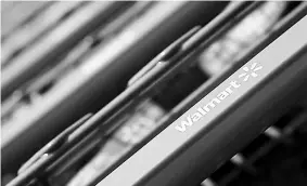  ??  ?? Shopping carts are seen outside a new Wal-Mart Express store in Chicago. — Reuters photo