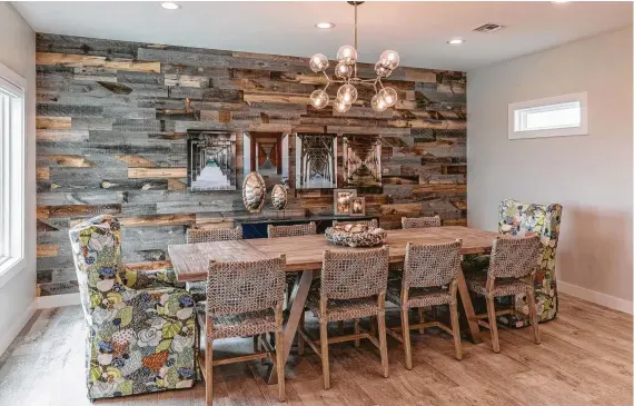  ?? Photos by Braun Photograph­y ?? The rustic shiplap on this dining-room wall has a surprise: It’s peel-and-stick paneling that’s easily applied. Colors in the upholstery on the captain’s chairs created the color palette that runs through the entire home.