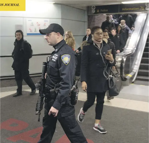  ?? BRYAN R. SMITH/AFP/GETTY IMAGES ?? Police stand guard as commuters evacuate after a pipe-bomb exploded in a terror attack at the Port Authority Bus Terminal in New York City on Monday. The blast, during a busy time of morning in downtown Manhattan, was relatively minor, with only three...