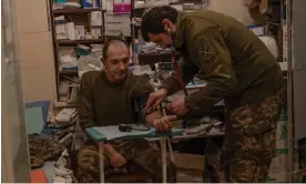  ?? ?? Vitalii Harnik treats a soldier, Andrii, at a hospital in the Donetsk region. Andrii was concussed when a Russian drone dropped a bomb into his foxhole. Photograph: Alessio Mamo/ The Guardian