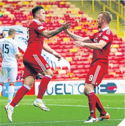  ??  ?? Miles Storey celebrates with Adam Rooney after making it 2-0 to Aberdeen. GRAEME SHINNIE is one of those consistent “seven out of 10” guys managers build teams around. His presence has been vital for Aberdeen over the last year – and was again against...