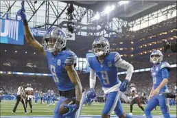  ?? AP photos ?? Lions wide receiver Josh Reynolds celebrates with teammates Jameson Williams (center) and Jared Goff (right) after scoring a touchdown during the first half of Detroit’s 31-23 win over Tampa Bay in a divisional playoff game Sunday.