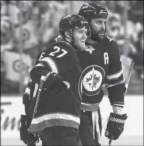  ?? CP PHOTO ?? Winnipeg Jets’ day. Nikolaj Ehlers (27) and Dustin Byfuglien celebrate a goal Tues-