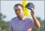  ?? Chris Carlson / Associated Press ?? Francesco Molinari, of Italy, tips his hat on the 18th green during the third round of the Masters golf tournament on Saturday in Augusta, Ga. Molinari is in first place heading into the final round.