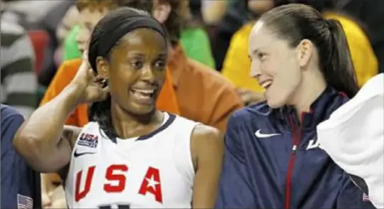  ?? Elaine Thompson ?? Swin Cash and Sue Bird relax on the bench in the final moments of an Olympic basketball game. Cash and Bird were teammates at Connecticu­t, on the U.S. Olympic team and with the WNBA's Seattle Storm.