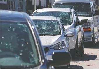  ??  ?? Saturday’s intense hailstorm created a massive amount of damage to cars parked in Saddle Ridge.