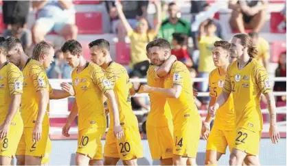  ??  ?? A victorious Australian team celebrate after their consummate 3-0 win over Palestine on Friday.