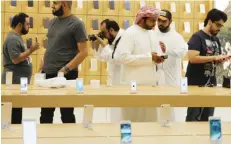  ??  ?? DUBAI: Customers gather at an Apple store during the launch of the new iPhones yesterday at the Mall of the Emirates. — AFP