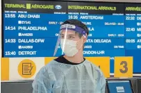  ?? FRANK GUNN THE CANADIAN PRESS ?? A worker waits for arrivals at the COVID-19 testing centre in Terminal 3 at Pearson Airport in Toronto on Wednesday.