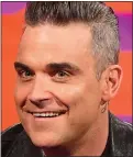  ??  ?? CHIN UP: Robbie with fillers