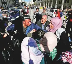  ?? Reuters ?? Protesters argue with a member of Palestinia­n security forces as the forces disperse a Hamas demonstrat­ion in Hebron in the Israeli-occupied West Bank yesterday.