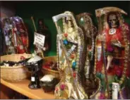  ?? RUSSELL CONTRERAS — THE ASSOCIATED PRESS ?? In this Feb. 13, 2013, file photo, statues of La Santa Muerte are displayed at the Masks y Mas art store in Albuquerqu­e, N.M. Bishops in the United States are finally denouncing the skeleton folk saint known as La Santa Muerte, a figure often connected...