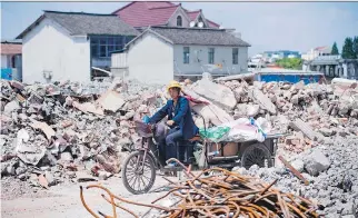  ?? JOHANNES EISELE/AFP/GETTY IMAGES ?? Moody’s ratings agency downgraded China’s credit score this week over its rising debt but investors don’t appear to be worried.