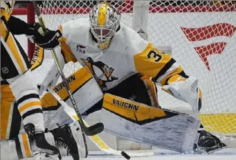  ?? Associated Press file photo ?? Penguins goaltender Alex Nedeljkovi­c stops a shot in the second period against the Avalanche on March 24 in Denver. Nedeljkovi­c has gone 4-0-2 in the past six games.