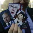  ?? SEAN KILPATRICK/THE CANADIAN PRESS ?? NDP MP Charlie Angus holds up a deck of ’Senate Hall of Shame’ collector cards Monday.