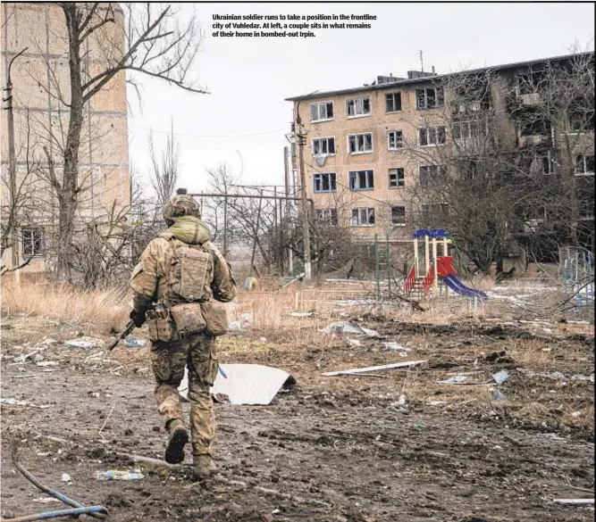  ?? ?? Ukrainian soldier runs to take a position in the frontline city of Vuhledar. At left, a couple sits in what remains of their home in bombed-out Irpin.