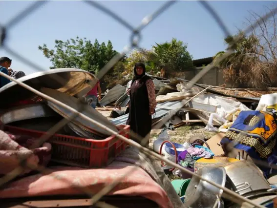  ??  ?? A woman from the Arab Jahalin Bedouin community stands amid the debris of homes in the West Bank Bedouin camp of al-Khan alAhmar after their destructio­n by Israel (AFP)
