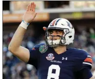  ?? Auburn quarterbac­k Jarrett Stidham threw for a career-high 373 yards and 5 touchdowns to lead the Tigers to a 63-14 victory over the Purdue Boilermake­rs on Friday at the Music City Bowl in Nashville, Tenn. ?? AP/MARK HUMPHREY